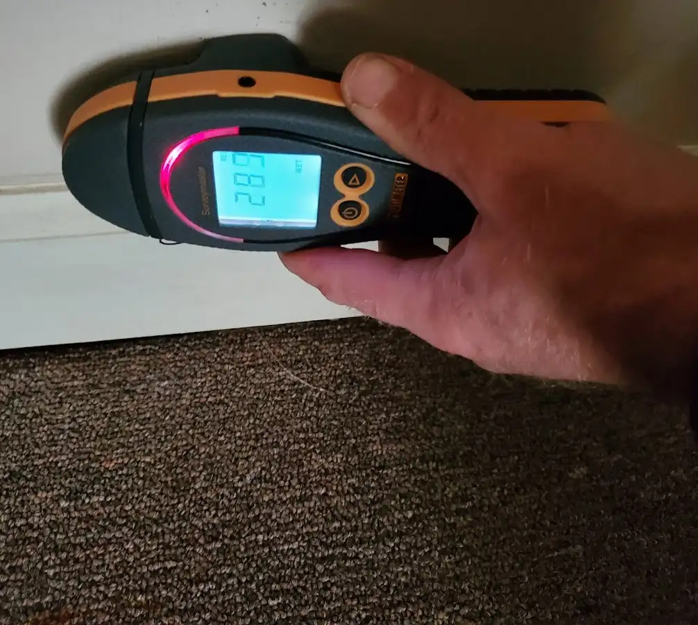 Moisture detection at baseboard during Storm Damage Restoration in Stone Mountain